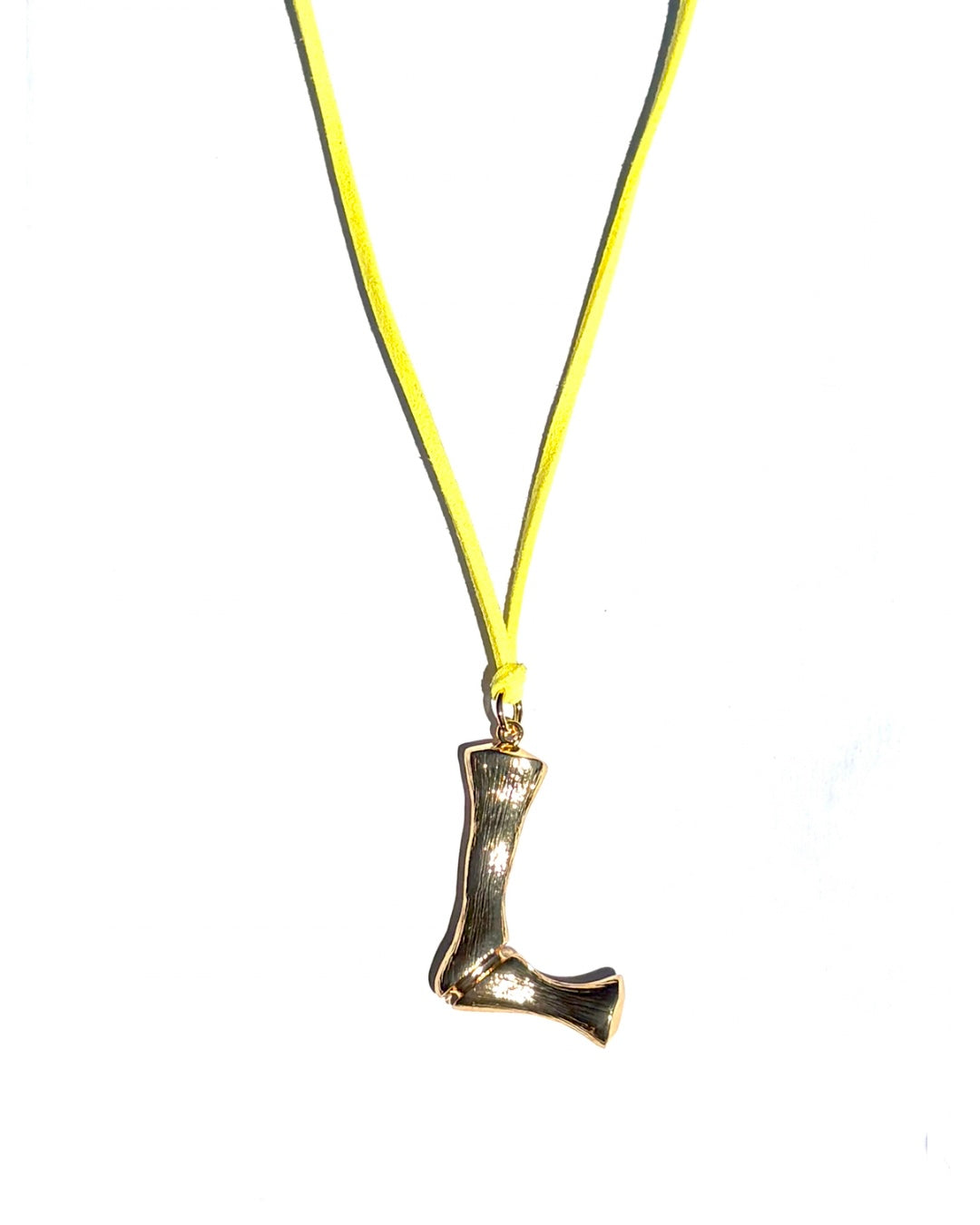 The Clásico by LAZO Collective: gold bamboo-style initial pendant on a maize yellow or azul blue suede tie cord