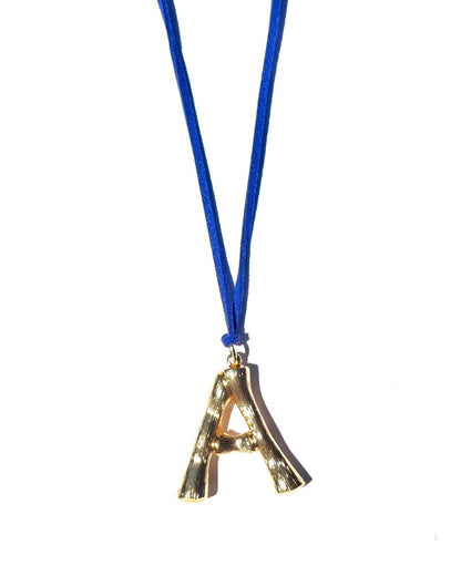 The Clásico by LAZO Collective: gold bamboo-style initial pendant on a maize yellow or azul blue suede tie cord