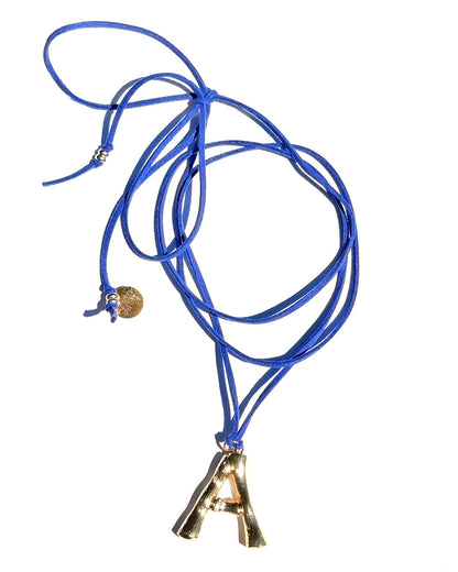 The Clásico by LAZO Collective: gold bamboo-style initial pendant on a maize yellow or azul blue suede tie cord