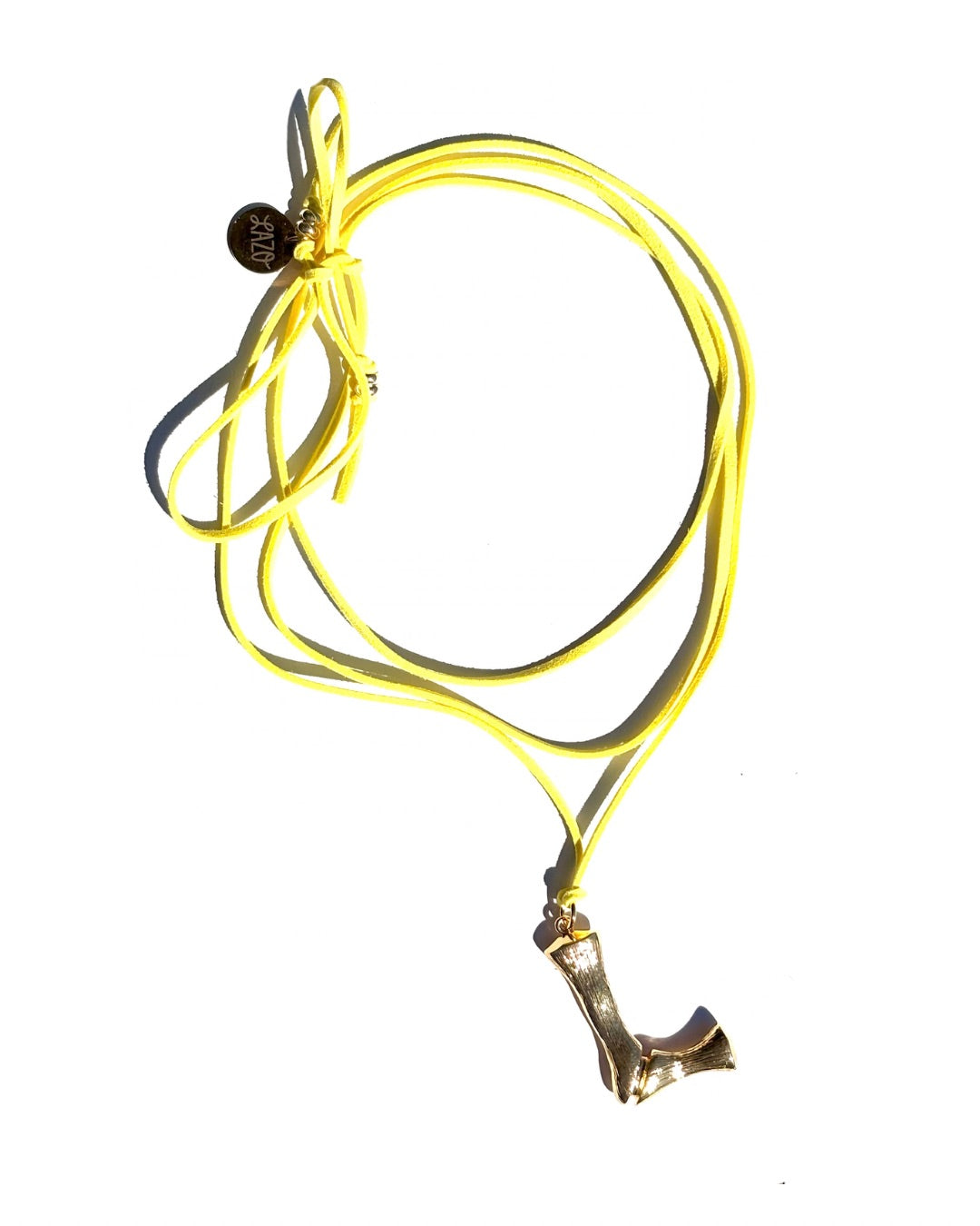 The Clásico by LAZO Collective: gold bamboo-style initial pendant on a maize yellow or azul blue suede tie cord